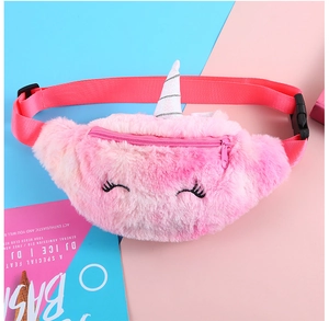 Detailed view of plush unicorn belt bag with embroidered eyes and adjustable pink strap