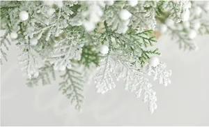 Macro shot of snowy pine needles with white flocking and decorative berries for Christmas