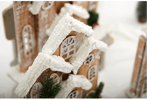 Close-up of wooden Christmas house featuring fluffy snow texture and natural wood grain