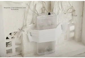 Detail of clear battery box with switch for lighted wooden house Christmas ornaments