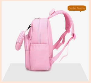 Side view of pink school backpack with zipper details and a round coin purse pendant