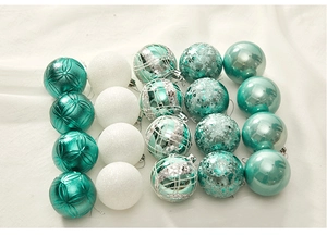 Flat lay view of 16-piece turquoise and white Christmas ornaments set on white fabric