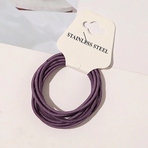 Close-up of high-elastic purple hair ties displayed on a white paper packaging card