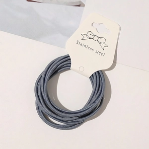 Detail of blue high-elastic hair tie bundled on white card with stainless steel joint