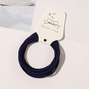Detail of high-elastic navy blue hair ties bundled on a white card display