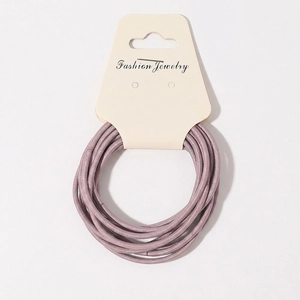 Set of ten lavender elastic hair ties with woven texture on a white branded display card