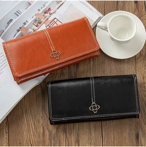 Detailed view of long wallets with clover metal buckle and contrast stitching accents