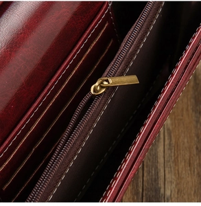 Macro shot of retro wine red oil wax leather wallet with zipper pocket and card slots