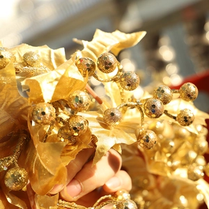 Golden Christmas berry branch with shiny glitter and metallic sequins for holiday decor