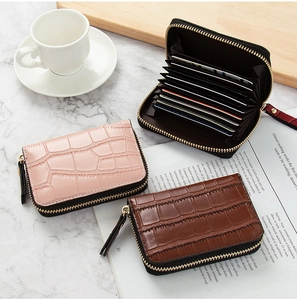Detail of crocodile embossed card holders in pink, brown and black with accordion slots