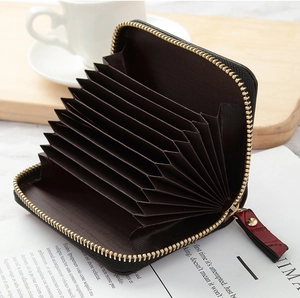 Detail of accordion-style card slots with gold metal zipper and leather puller