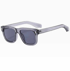 Detail of smoke grey sunglasses with metallic rivets and textured anti-slip temples