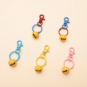 Colorful five-piece metal keychain set with bulldog charms, yellow bells, and lobster clasps