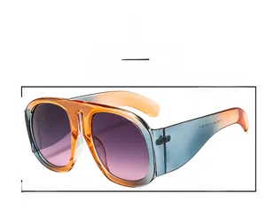 Detailed view of oversized orange and blue gradient frame with purple tinted lenses