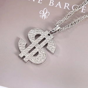 Macro detail of silver dollar sign pendant with S925 hallmark and sparkling rhinestones