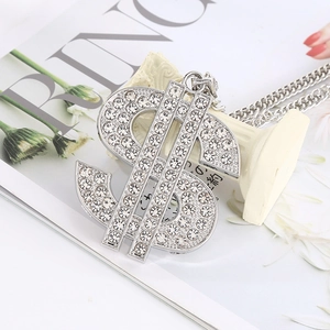 Macro shot of silver dollar sign pendant with iced-out rhinestones on thick metal chain