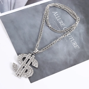 Macro shot of silver dollar sign pendant with cubic zirconia and S925 engraved clasp