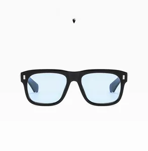 Detail view of black square sunglasses frame with silver metal accents and light blue lens