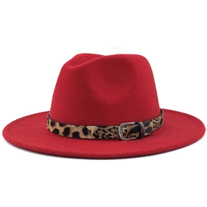 Close-up of red wool fedora hat featuring a stylish leopard print belt and silver buckle