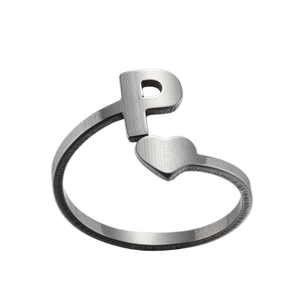 Detail of silver letter P and heart ring with brushed metal texture and open band