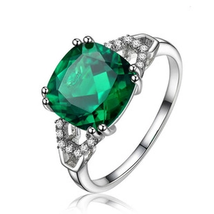 Macro detail of vintage emerald square ring with pavé zircon stones in silver finish