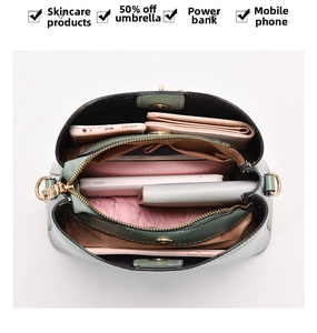 Deep green satchel interior view with multiple compartments showing ample storage space