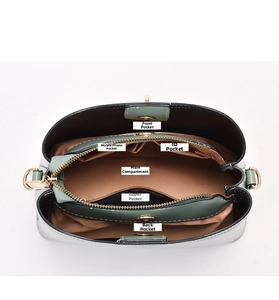 Macro view of interior compartments and pockets of a green bow minimalist handbag