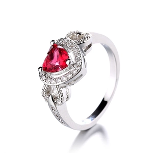 Elegant heart-shaped red zircon ring with silver metal band and pavé white diamonds