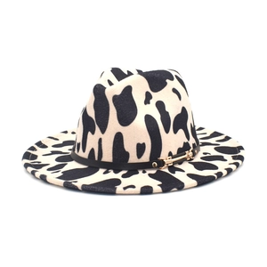 Cow print fedora hat in black and white wool felt with black band and gold buckle detail