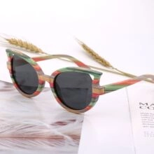 Detail of multi-colored wooden texture cat-eye sunglasses on a rustic magazine background