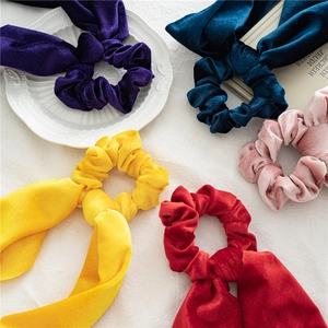 Velvet 2-in-1 ponytail bow scrunchies set in assorted colors on elegant white fabric