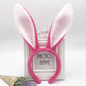 Close-up of cute pink and white plush rabbit ear headband with soft fluffy texture