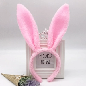 Detailed view of a pink plush sequin bunny ear headband with decorative white photo frame