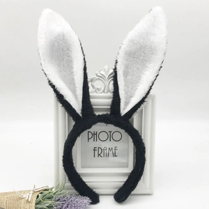 Close-up of white and black plush rabbit ear headbands with soft sequins and lavender