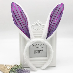 Detail of white plush rabbit ears headband with purple sequin polka dots for Easter party