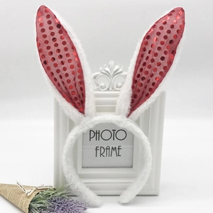 Close-up of plush white bunny ears headband with glittery red sequin inner lining