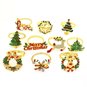 Detailed set of 10 gold metal Christmas napkin rings with reindeer and tree designs