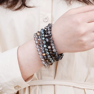 Elastic multi-layer crystal bead bracelet with dark faceted glass beads on wrist