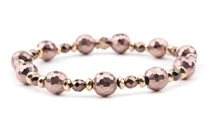 Macro detail of faceted rose gold and bronze glass beads on an elastic DIY bracelet