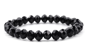 Detailed view of elastic beaded bracelet featuring faceted black glass crystals