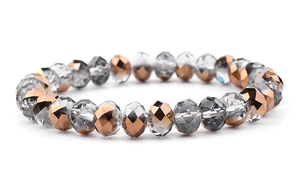 Macro shot of faceted crystal glass beads in rose gold and clear tones for DIY bracelets