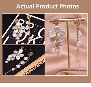Detailed view of asymmetric Baroque pearl earrings with golden flower accents and tassel
