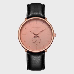Close-up of Khorasan rose gold watch face with black leather strap and textured dial