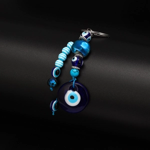 Detail of blue Evil Eye beaded keychain featuring multiple beads and a large circular charm