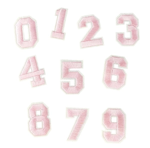 Close-up of pink embroidered 0-9 number patches with fine white stitched edges