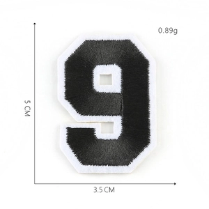 Detail showing embroidered number 9 patch in black and white measuring 5 CM high