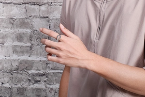 Detail eines minimalistischen silbernen Ringes mit Nummer 8 Motiv am Zeigefinger