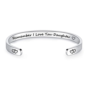 Close-up of engraved 'Remember I Love You Daughter' message on silver steel cuff bracelet