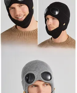 Detail of pilot knit beanie with goggles showing ribbed texture and lens decoration