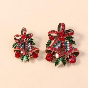 Detail of vintage Christmas bell brooches with red and green rhinestones on gold base
